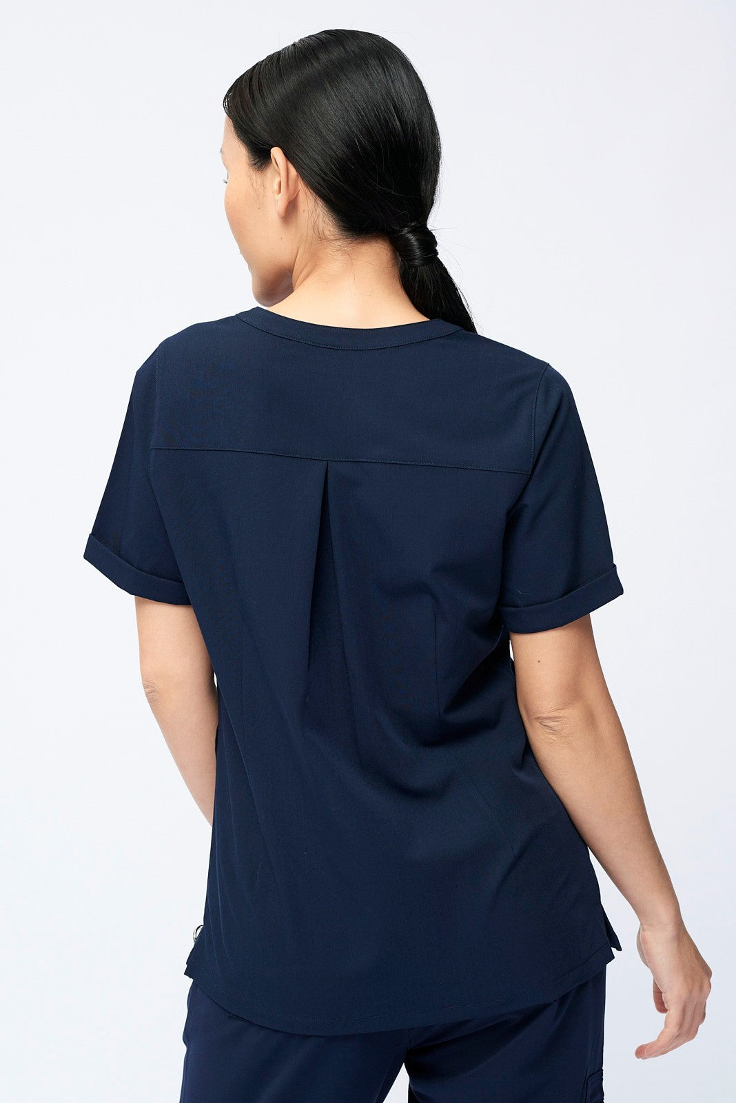 Nurse wearing a Dr. Woof Women's Short Sleeve Henley Scrub Top