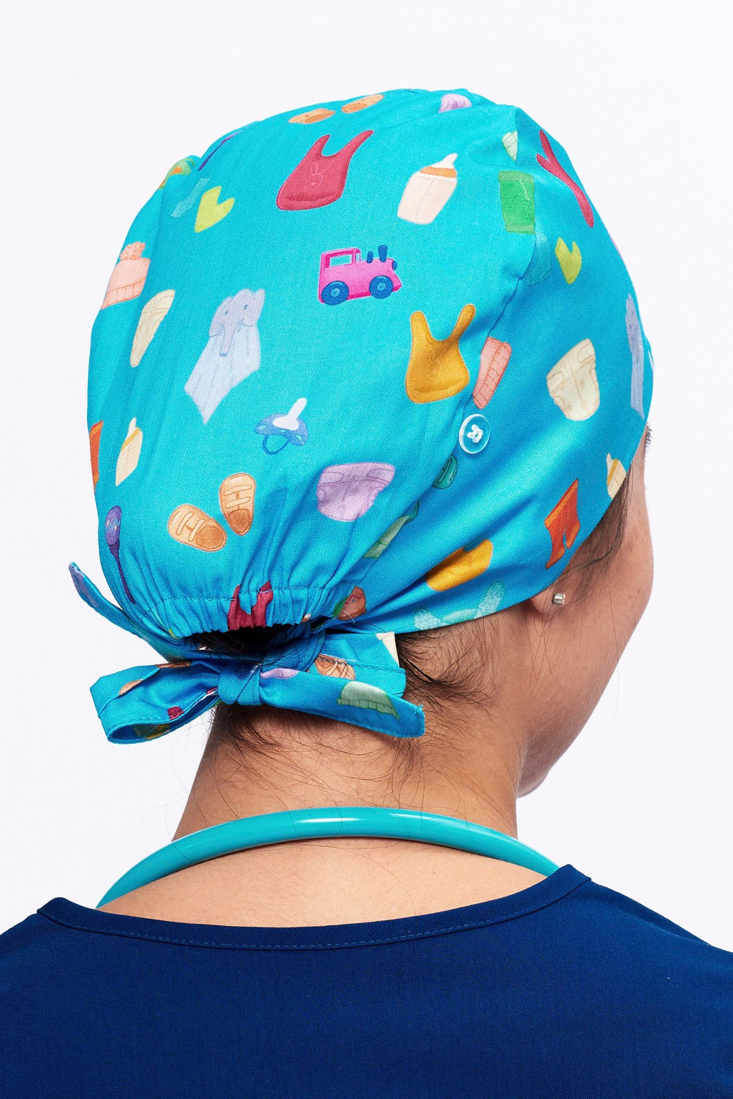 A Nurse wearing a Dr. Woof Goo Goo Gaa Gaa Surgical Scrub Cap 