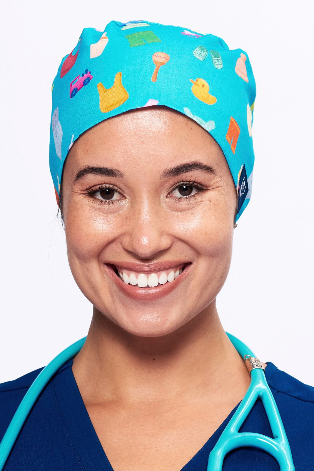 A Nurse wearing a Dr. Woof Goo Goo Gaa Gaa Surgical Scrub Cap Tie Back