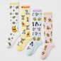 Studio layout displaying the Disney’s Winnie the Pooh Bamboo Compression Socks 4 Pack laid out side by side, featuring four distinct pastels: white floral Pooh print, pale yellow Hundred Acre Wood character print, light blue character face print, and soft pink hunny pot Pooh print—each styled with contrast "WOOF" top cuff branding.   