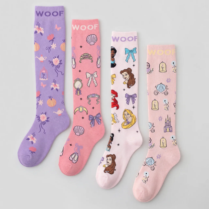 Flat lay display featuring four pairs of Disney Princess knee-high compression socks lined up side-by-side, including Magic Carriage & Lamp (lilac), Princess Icons (pink), Character Collage (light pink), and Cinderella (soft pink), all featuring "WOOF" top cuff branding.