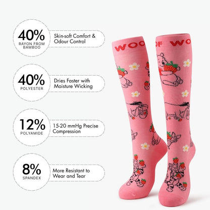 Infographic showing material percentages beside pink compression socks with Winnie the Pooh strawberry print.