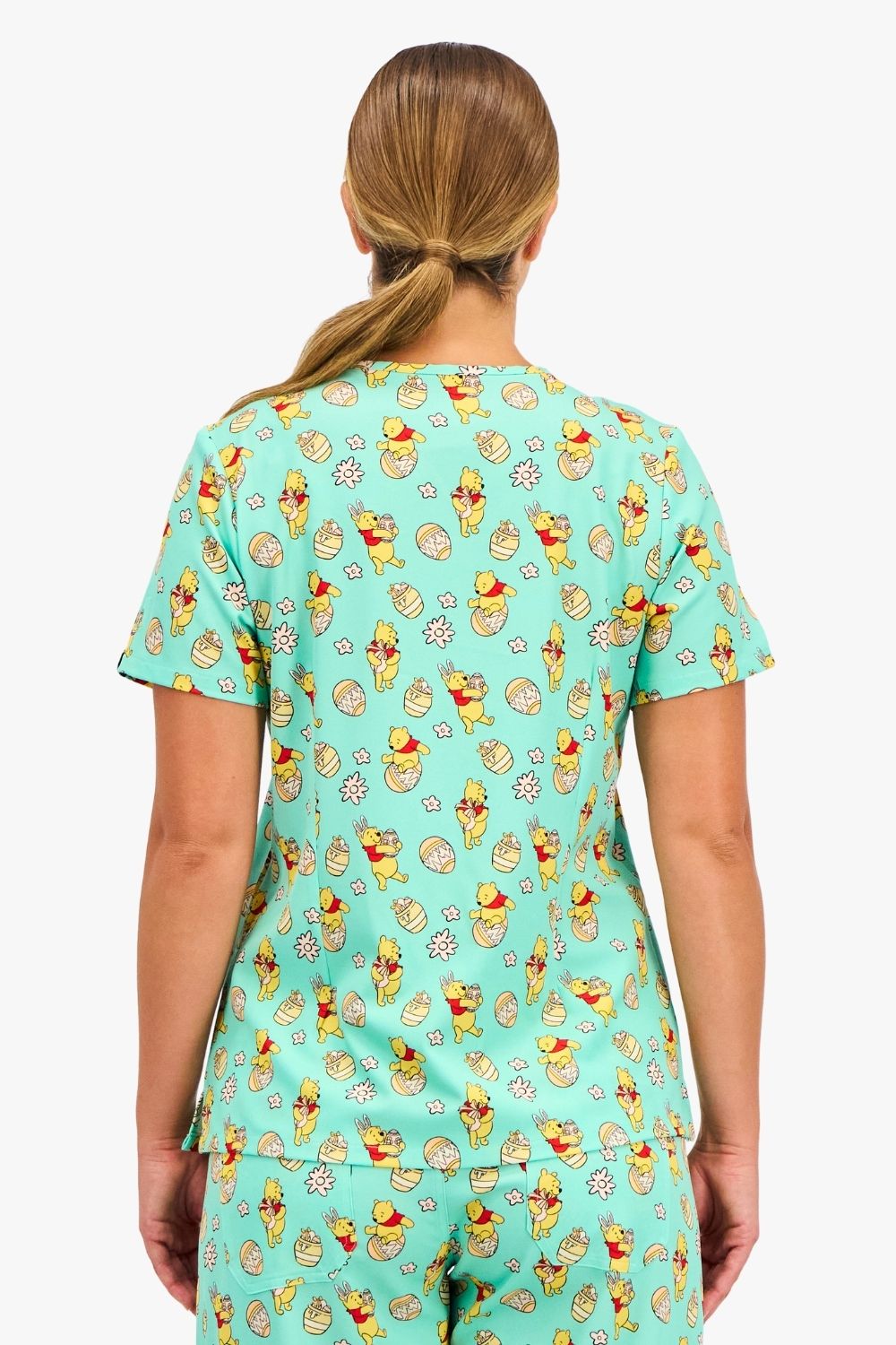 Disney’s Winnie the Pooh Women’s 3-Pocket Scrub Top, Easter Egg Hunt