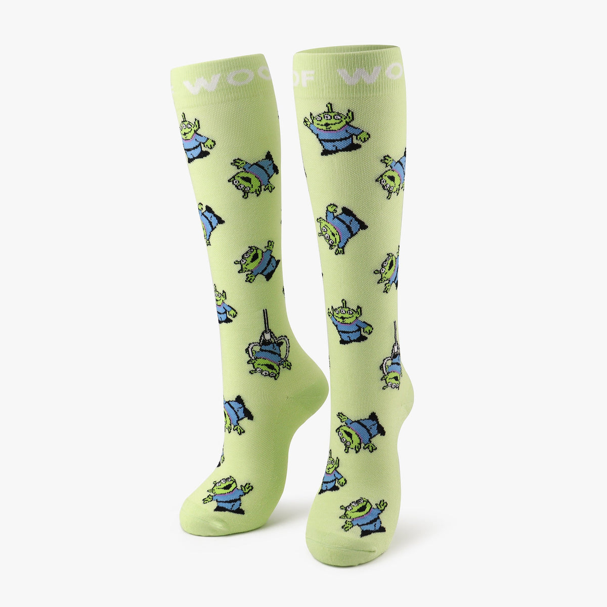 A pair of lime green compression socks featuring the Little Green Men from Disney and Pixar’s Toy Story. 