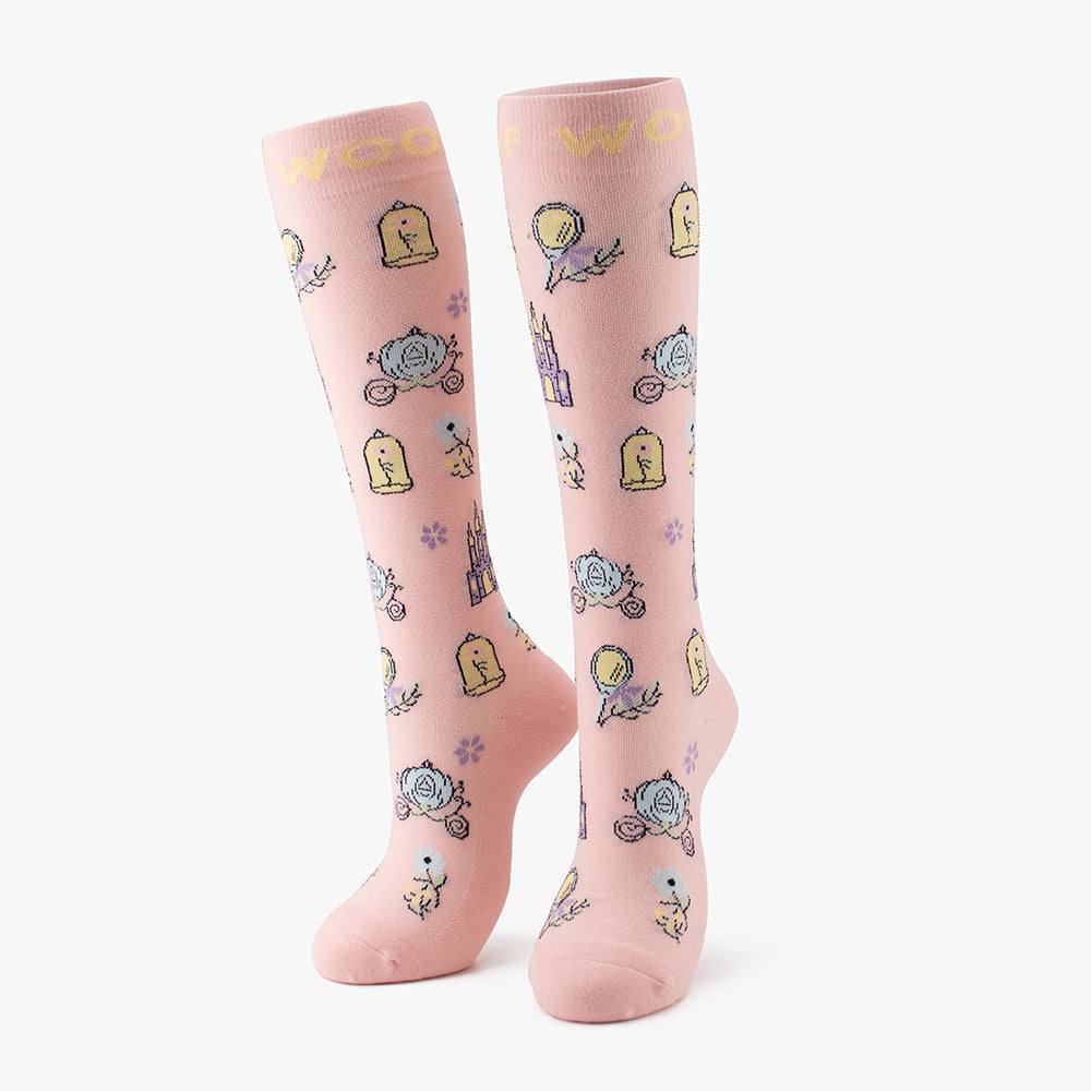 Side-by-side standing display of the soft pink Cinderella Disney Princess knee-high compression socks printed with castles, glass slippers, and carriage motifs.