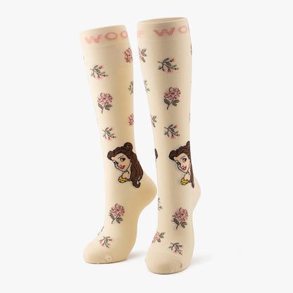 Side-by-side standing display of the cream Belle Disney Princess knee-high compression socks printed with roses and character illustrations.