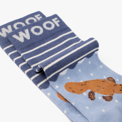 Folded view showing cute platypus illustration on blue bamboo crew compression socks with platypus design.