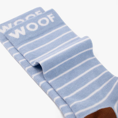 Folded view showing cute wombat illustration on light blue striped bamboo crew compression socks with wombat design.